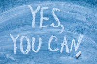 Motivational message "Yes you can!" written on a chalkboard
