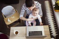 Mother with young child at laptop