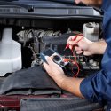 Automotive technician diagnosing engine trouble