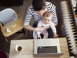 Mother with young child at laptop
